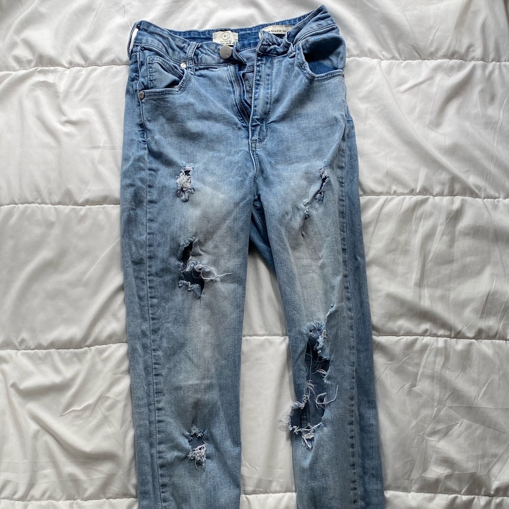 Distressed ripped blue jeans